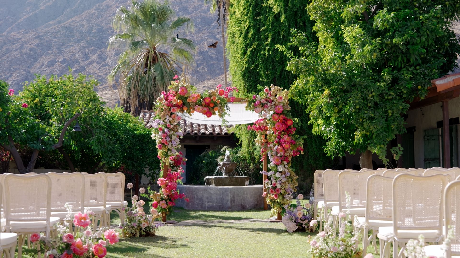 Outdoor wedding ceremony with a floral arch at Casa Cody in Palm Springs